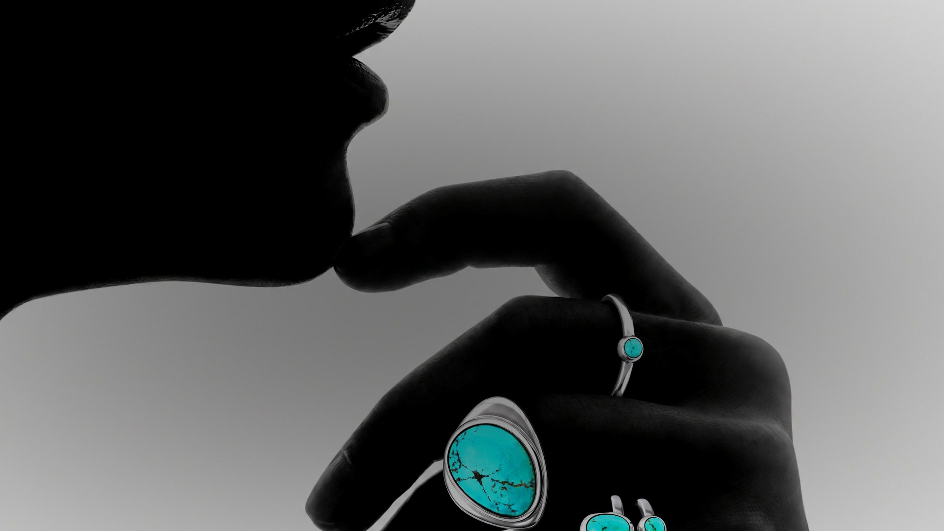 Hand wearing CHIRU silver rings set with turquoise — Silver, Stone, Skin.